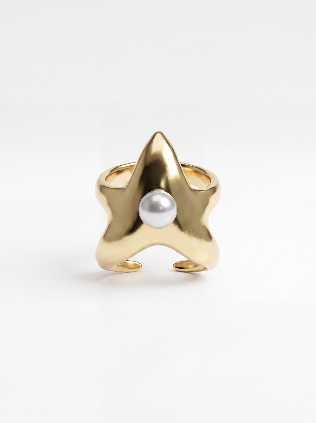 A gold star-shaped cuff with a single white pearl set in the center, photographed on a clean white background.