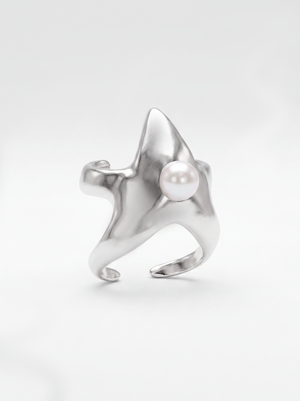 A white gold cuff shaped like a star featuring a central white pearl, photographed on a clean white background.