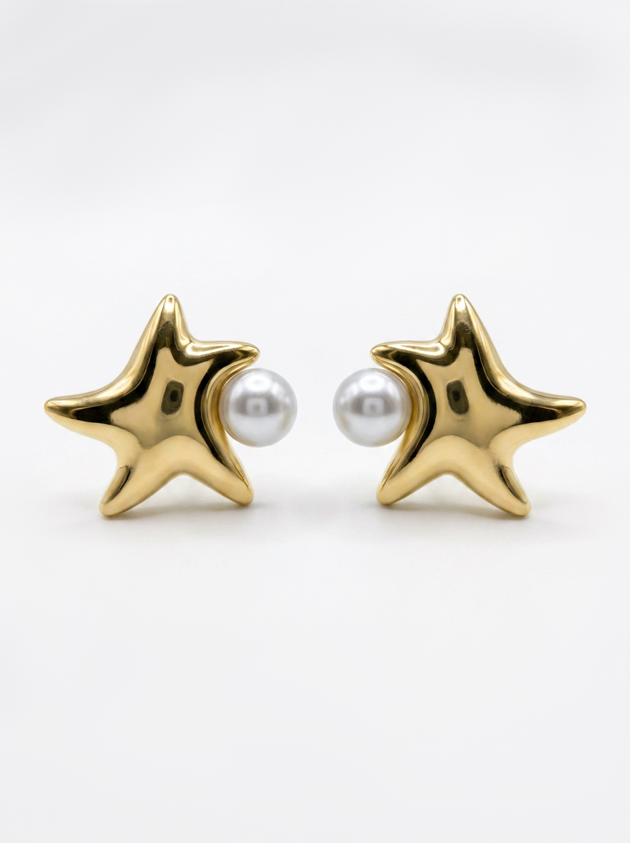 A pair of gold starfish stud earrings with a small white pearl set in the center of each star, shown on a clean white background.