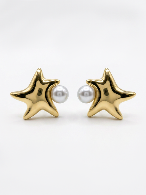 A pair of gold starfish stud earrings with a small white pearl set in the center of each star, shown on a clean white background.
