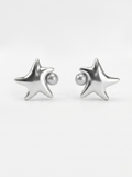 A pair of white gold star-shaped stud earrings with a small round pearl inset on each earring, shown against a clean white background.